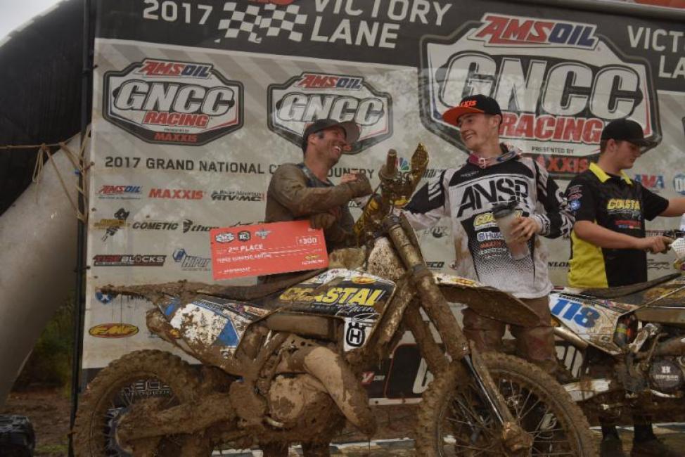 Team Manager Barry Hawk shares the podium celebration with Jack Edmondson.