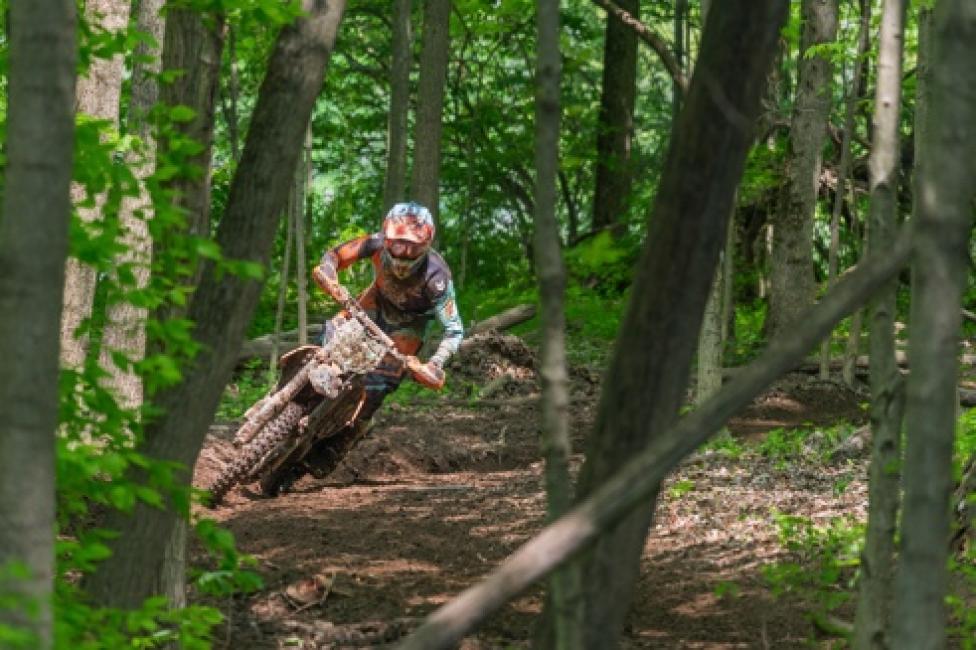 Ben Kelley carving through the trees on his KTM 250 XC-F.