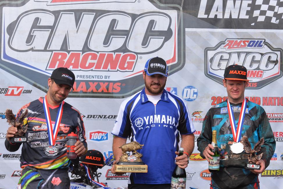 XC1 podium: (left) Adam McGill, Mark Notman (Fowler's mechanic), (right) Chris Borich 