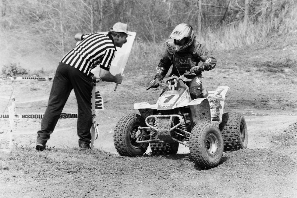 Looks like that's the man, the myth, the legend Buren Hamrick telling Barry Hawk he's got one lap to go at the 1995 Ocala GNCC