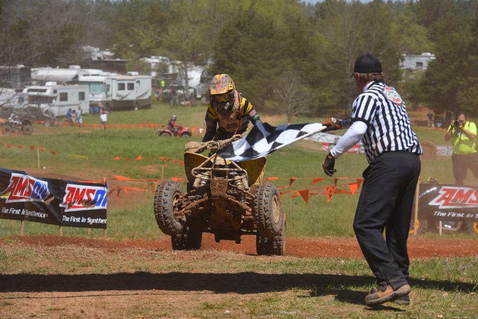 Hunter Hart, rider no. 211, grabs the checkereds at an earlier round of GNCC Racing this year.  Hart will be competing on both ATV’s and motorcycles this weekend at the inaugural Tomahawk GNCC in Odessa, New York.