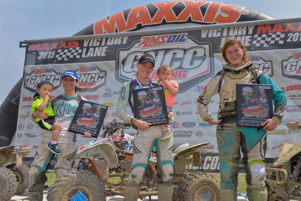 Next time these three make it on the podium together, someone bring Kylie a kid to hold! Photo: Ken Hill