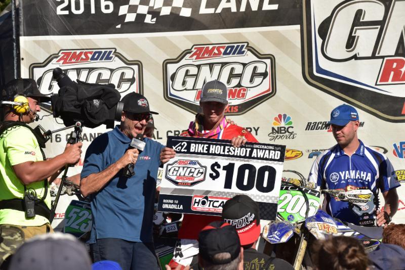 Layne Michael accepts the XC2 Holeshot Award atop the podium. Photo: Ken Hill