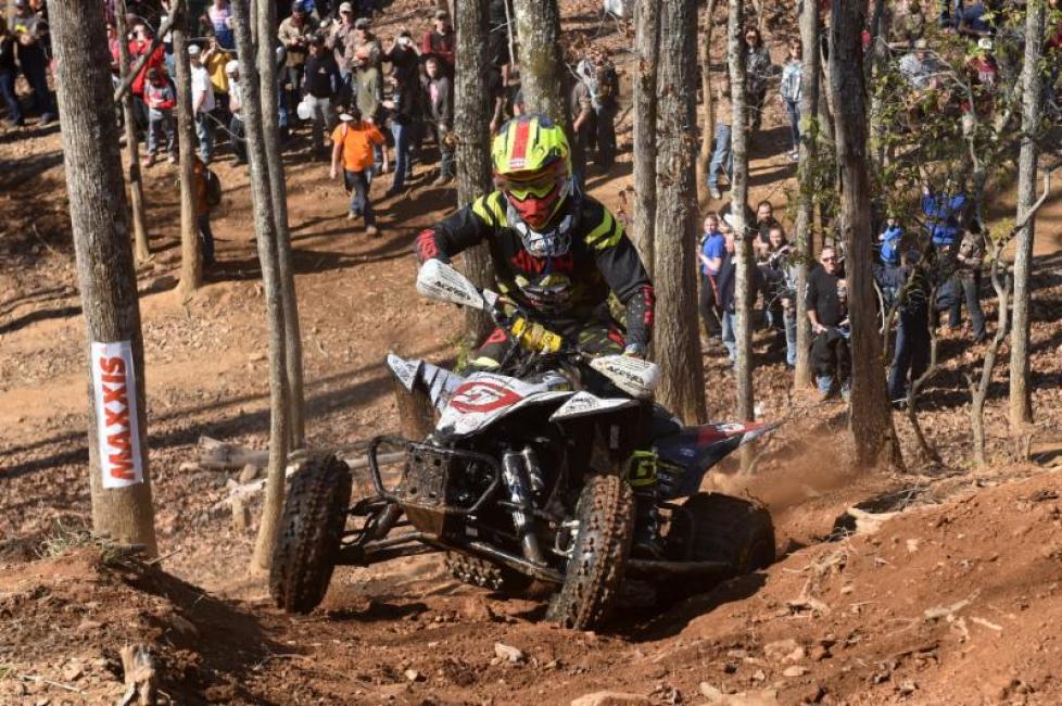 Brycen Neal pushes his Yamaha YFZ450R up the hill climb. 