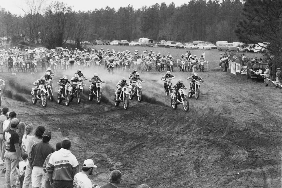 The Pro class heads for the woods at the Manchest State Forest GNCC in 1994. Riders include Duane Conner (14), Ty Davis (147), Scott Summers (2), Larry Roeseler (146), Scott Plessinger (6), Fred Andrews (1), Doug Blackwell (4) and desert racing great, Danny Hamel (145)