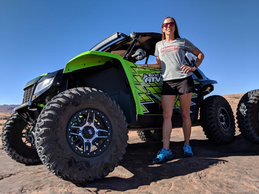 Alicia next to the UTV they used during their Ticket to Ride trip.
