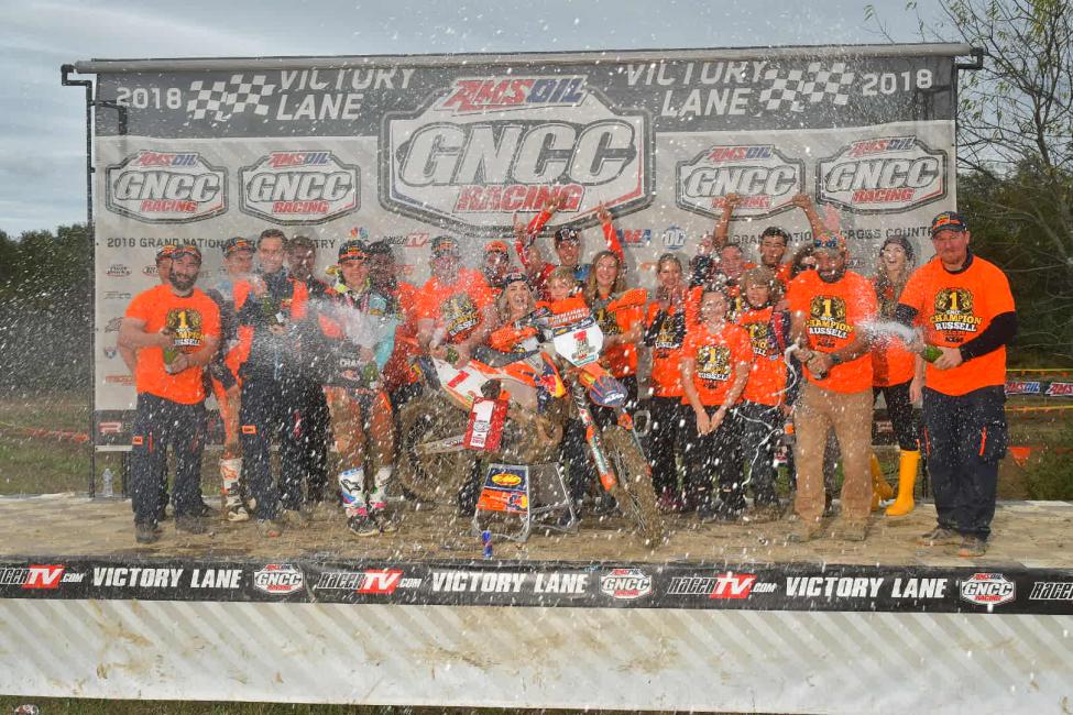 FMF/KTM Factory Racing celebrating Kailub Russell's Sixth-Consecutive GNCC National Championship with champagne showers. 