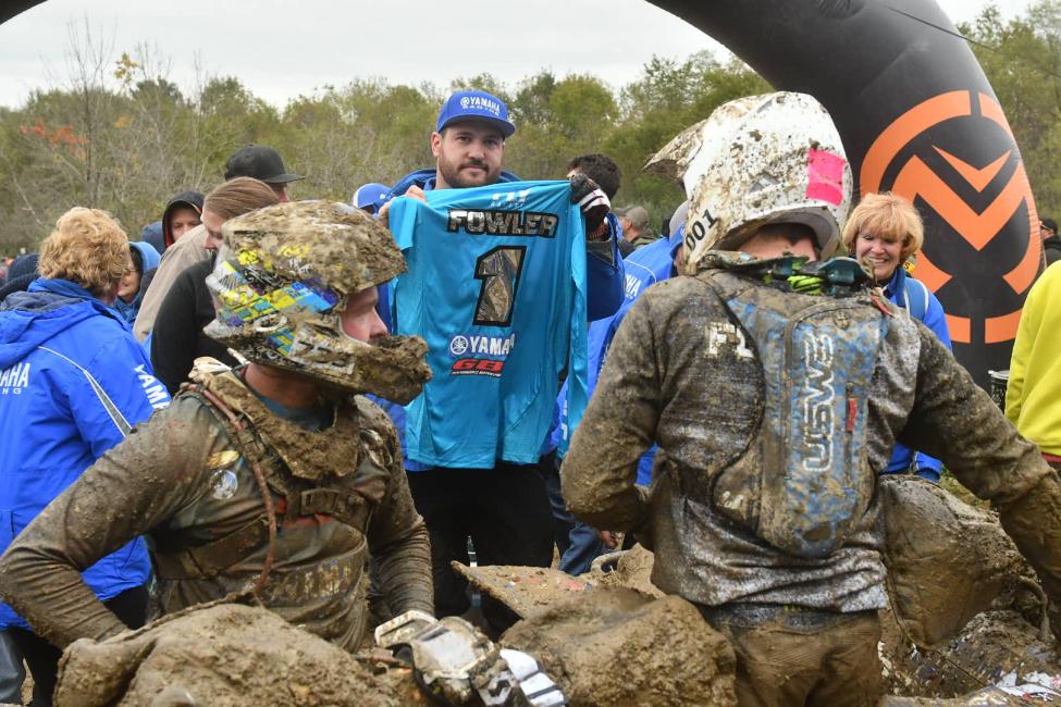 Walker Fowler's mechanic, Mark Notman, holds up the No. 1 jersey after his win at Powerline Park.