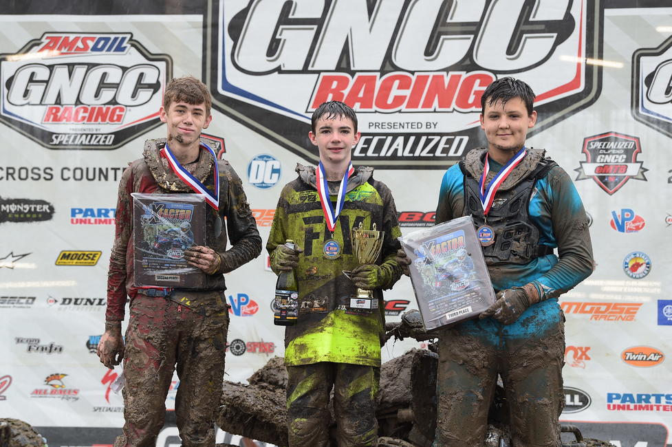Damien Hawkins (center), Paxton Dickerson (left) and Parker Henderson (right) made up the youth overall podium at the conclusion of the 8 a.m. youth ATV race.