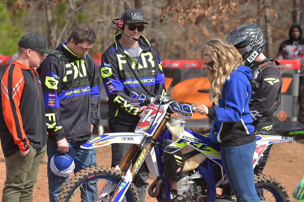 Steward Baylor alongside his wife, and some of FactoryONE Sherco's team members during the opening prayer at round one.