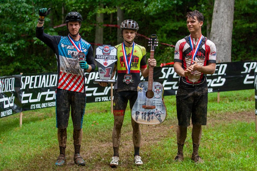 Kyle Smith stood in the center of the podium, earning the first-ever Specialized Turbo eMTB FIM North American race. Photo: Derek Garcia