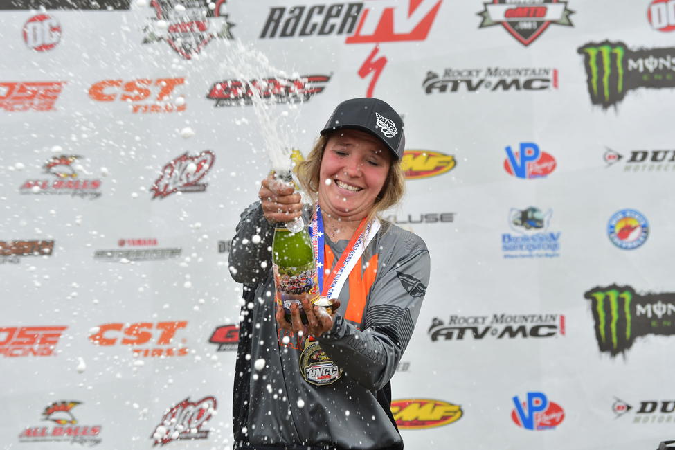 Elioff celebrates her WXC win with champagne showers. Photo: Ken Hill