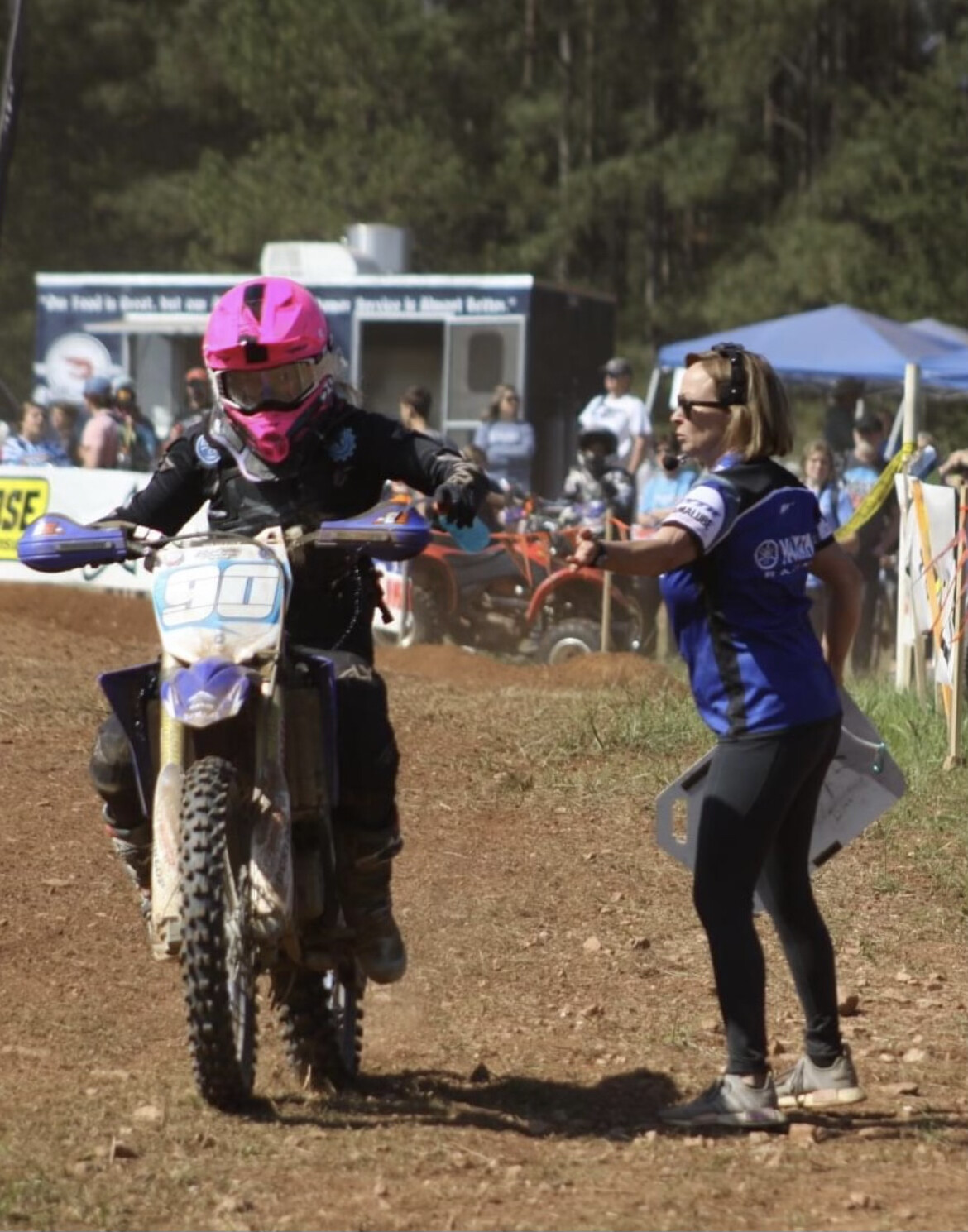Emily giving Prestin a crucial drink during one of her GNCC races.