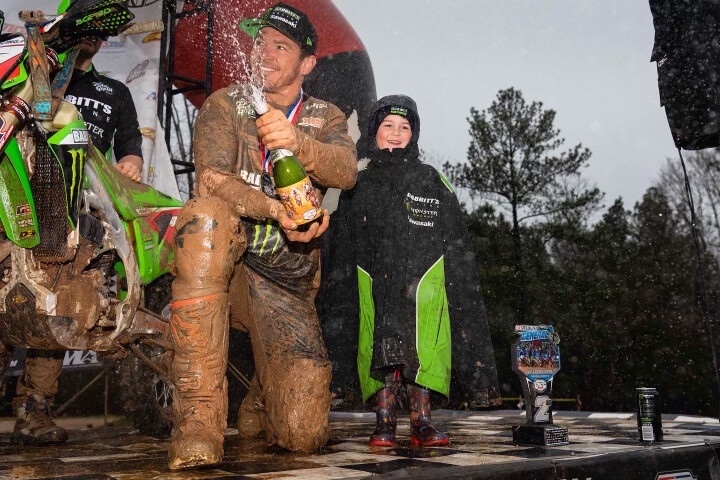 Josh with their son, Maverick, on the podium at The General GNCC this year.