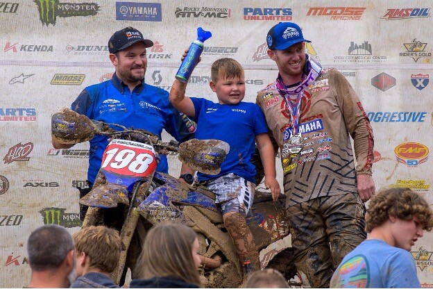 Draper on the podium after a muddy mess.