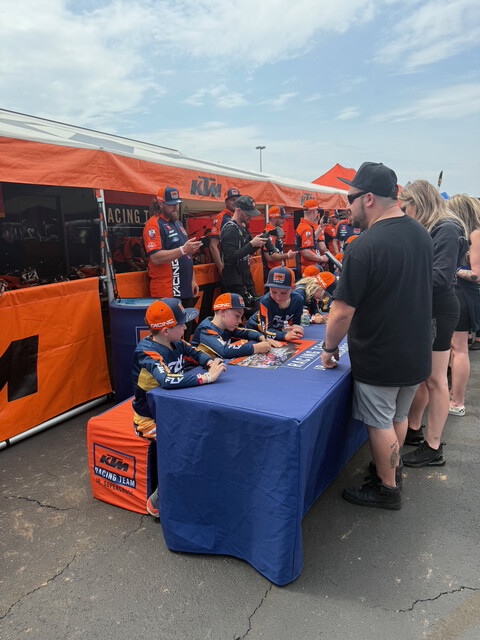 The boys signing autographs just like the top pro riders.