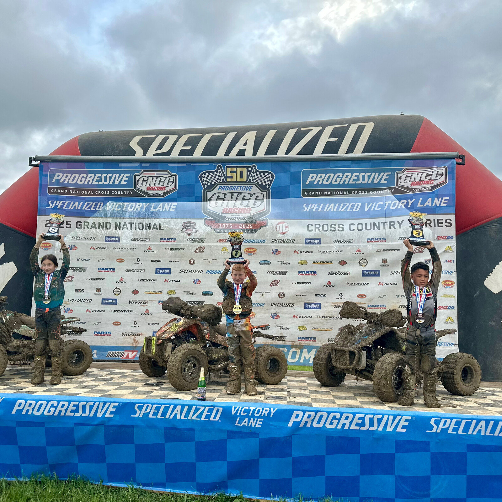 Casen Jennings (center) earned the Micro ATV overall win. Audrey Petrilla (left) and Justin Collins Jr. (right) rounded out the top three finishers.